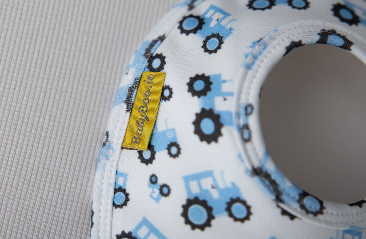 White and baby blue tractors organic cotton LittleBoo baby bib