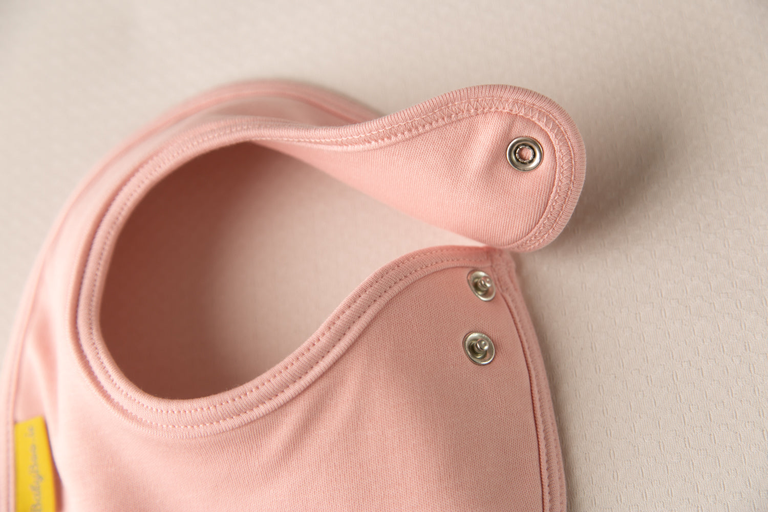 She's Here! organic cotton LittleBoo newborn bib