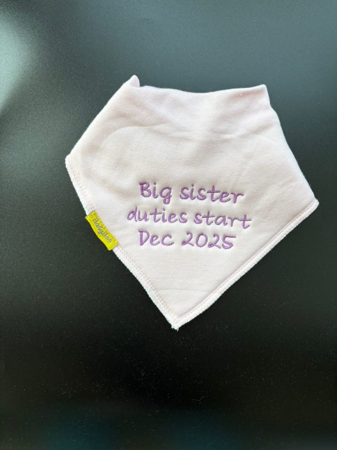 Big sister duties start Dec 2026 organic cotton DribbleBoo bandana bib