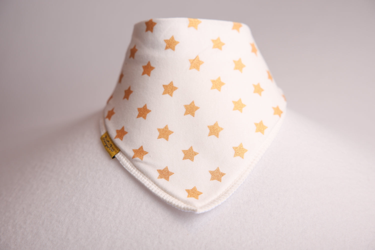 Gold stars on cream organic cotton DribbleBoo bandana bib
