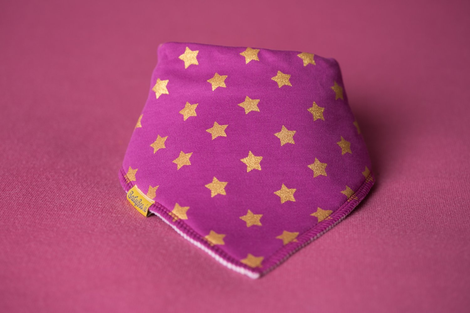 Plum with golden stars organic cotton DribbleBoo bandana bib
