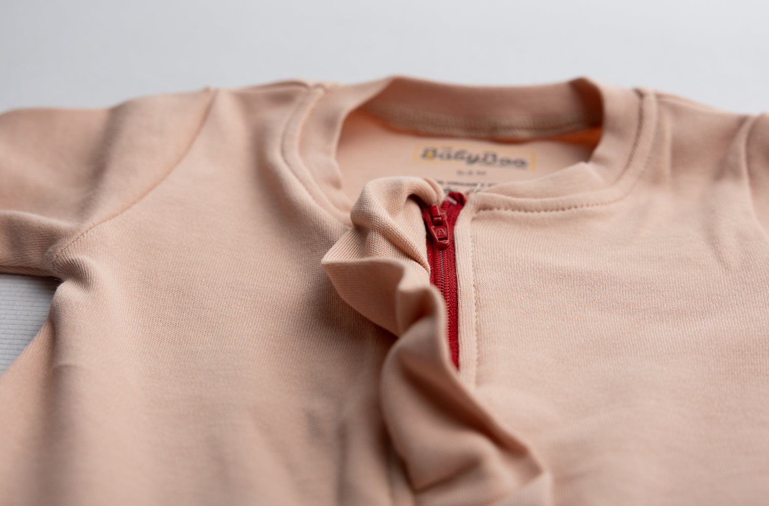 Peach ruffle organic cotton ZippyBoo suit
