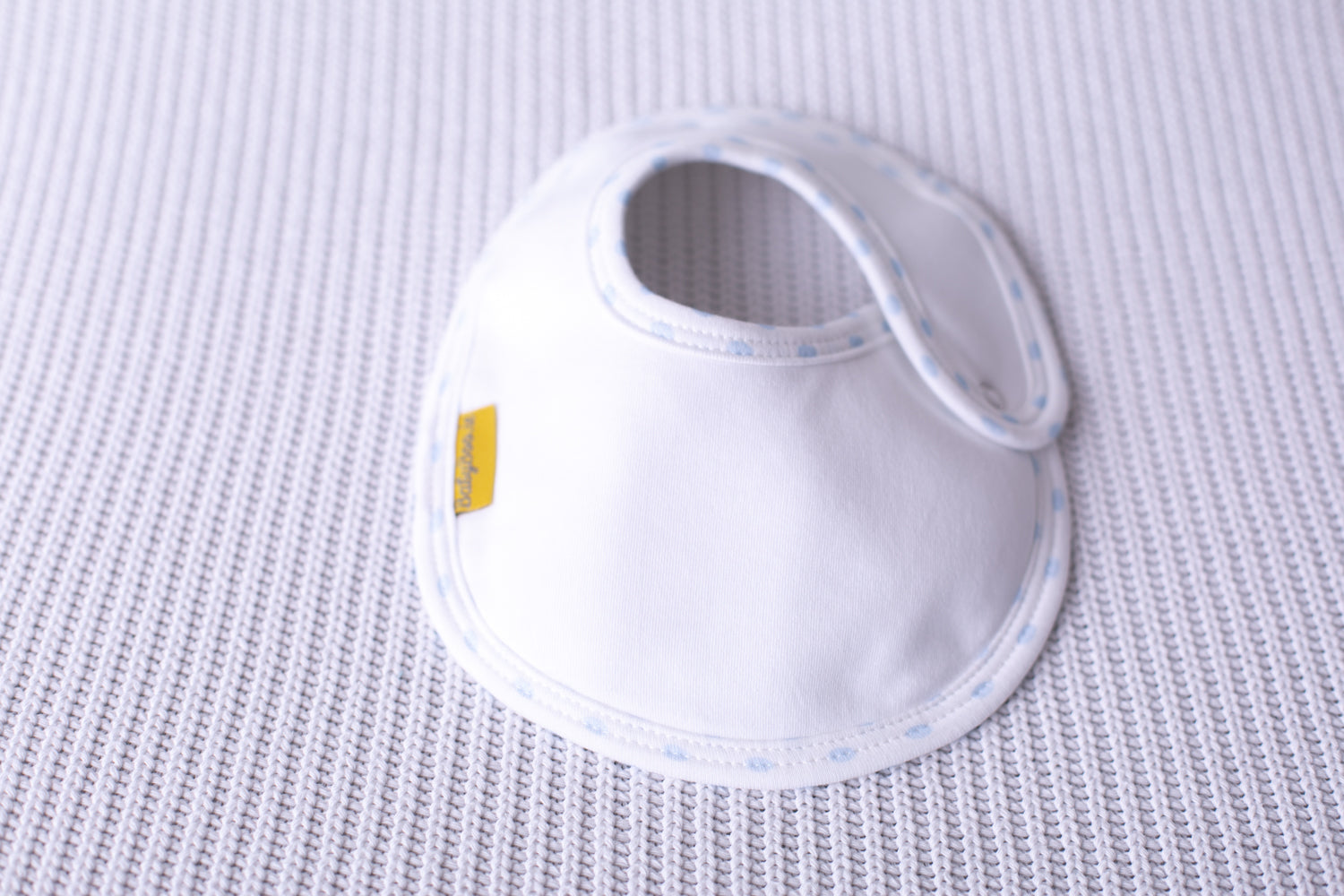 White with blue polka trim organic cotton LittleBoo baby bib