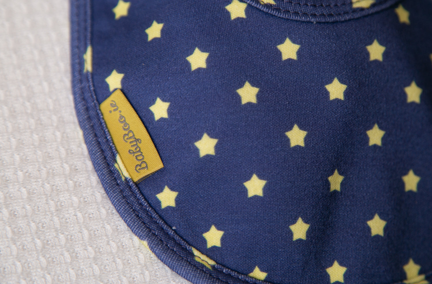 Navy with sunshine stars organic cotton LittleBoo baby bib
