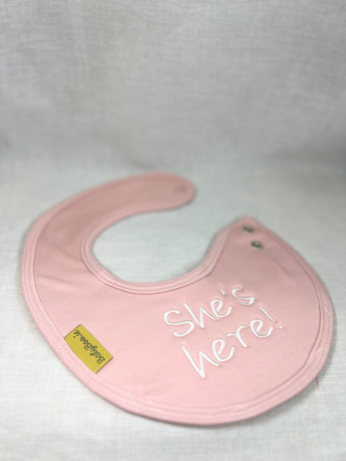 She's Here! organic cotton LittleBoo newborn bib
