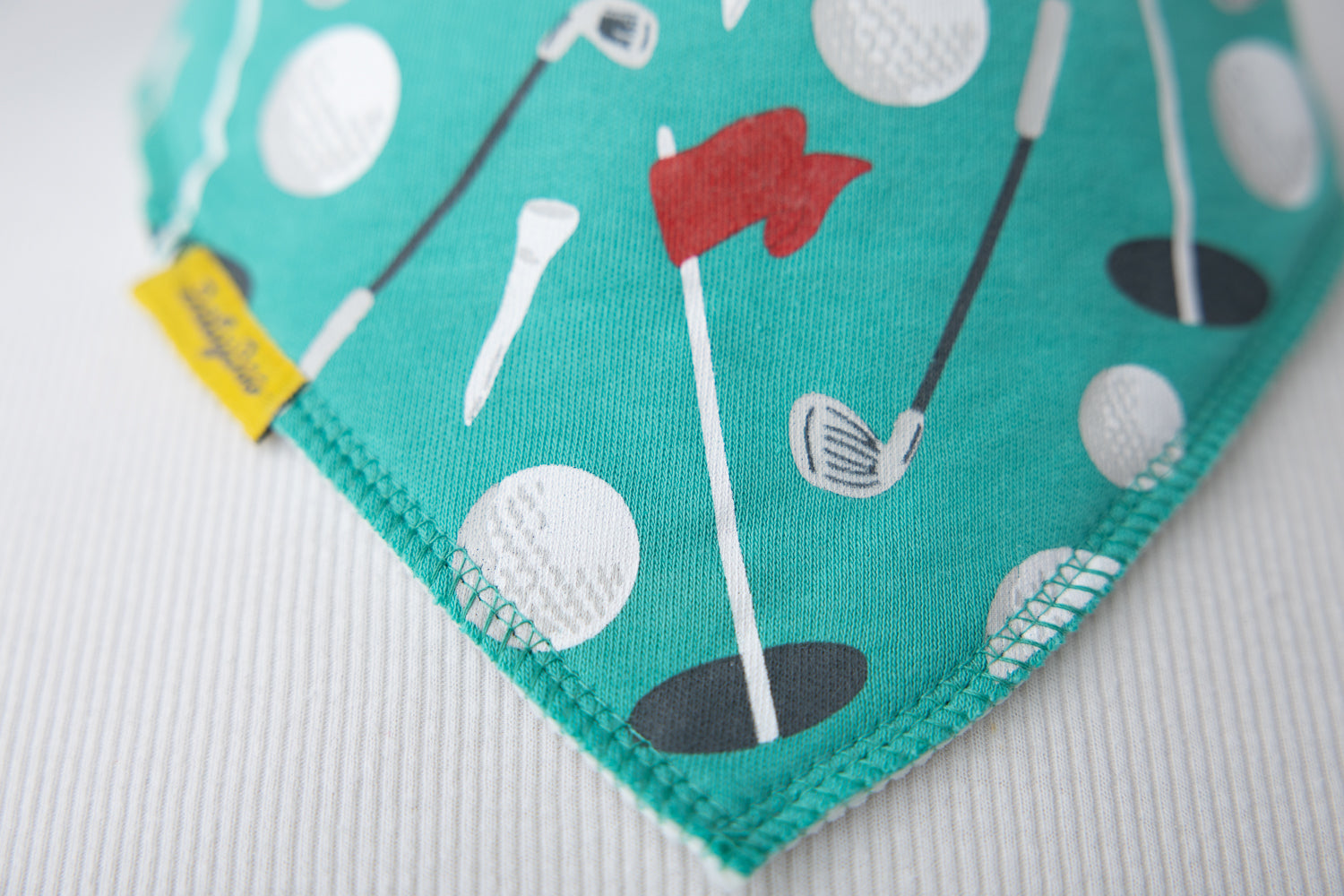 Teeing off organic cotton DribbleBoo bandana bib