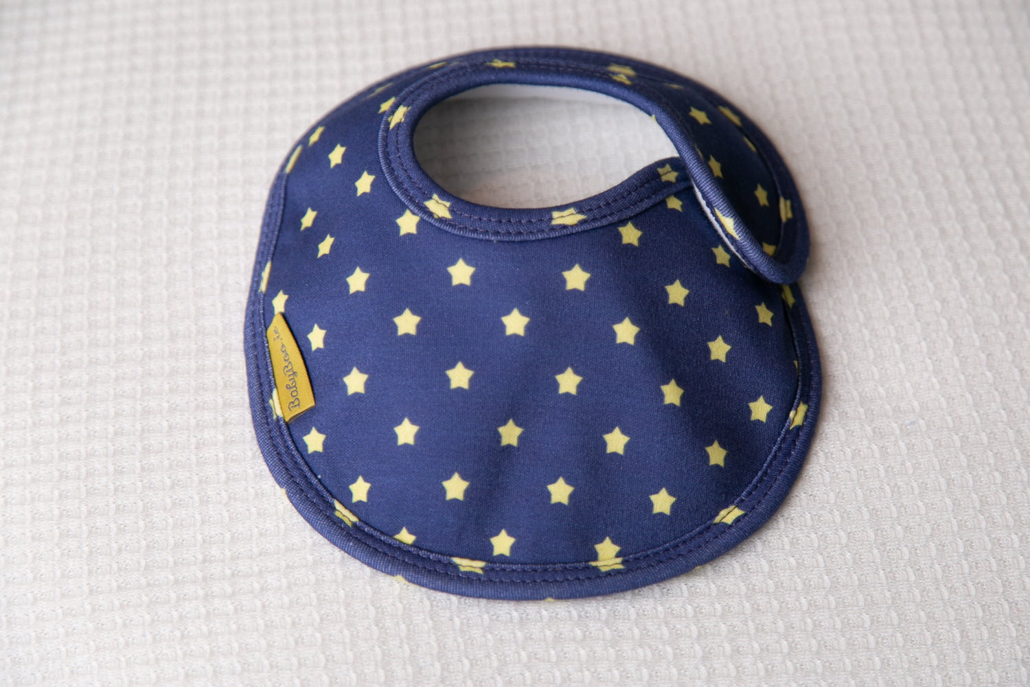 Navy with sunshine stars organic cotton LittleBoo baby bib