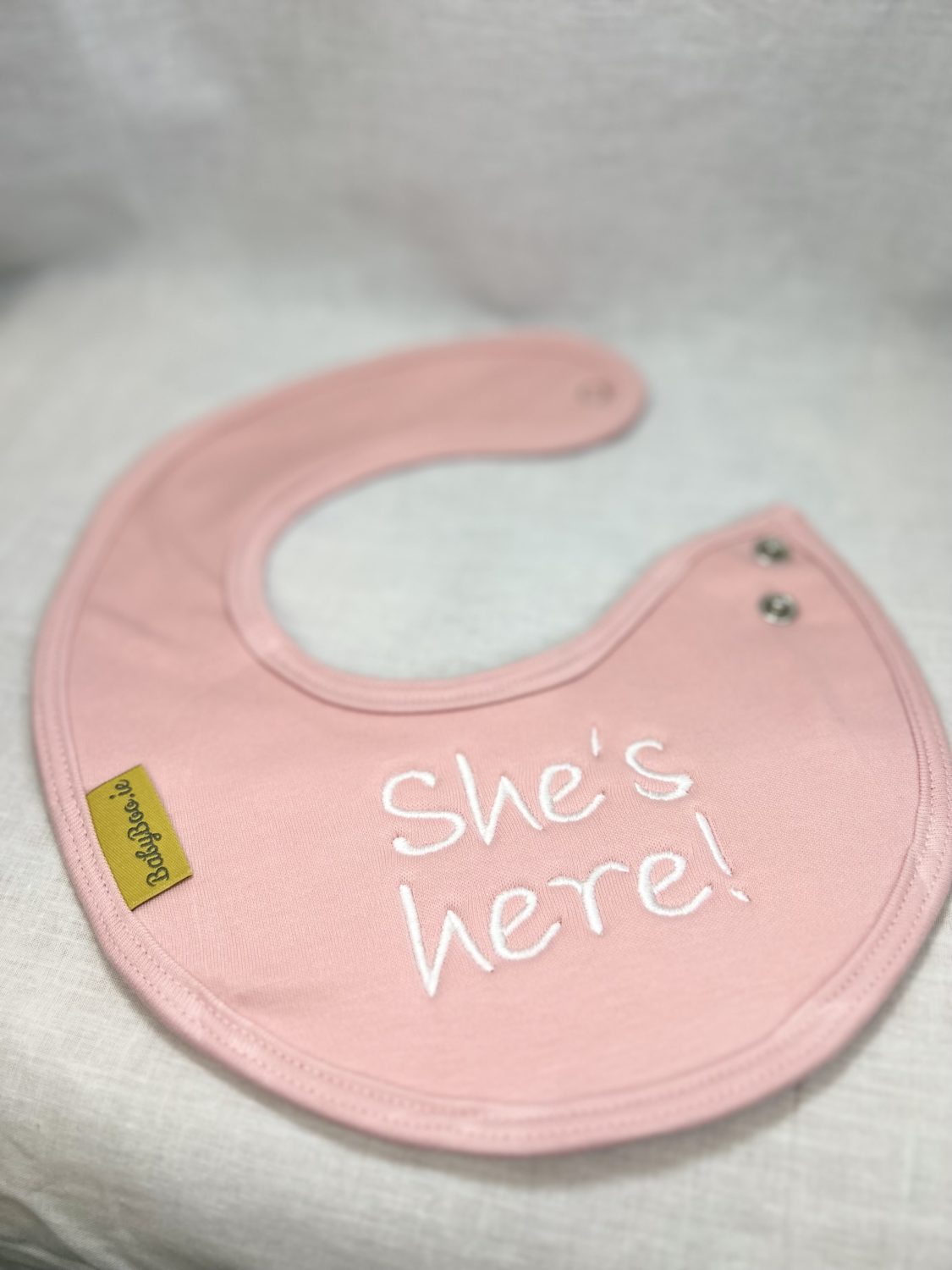 She's Here! organic cotton LittleBoo newborn bib