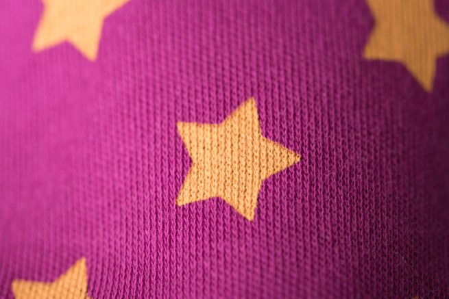 Yellow stars on plum bandana bib